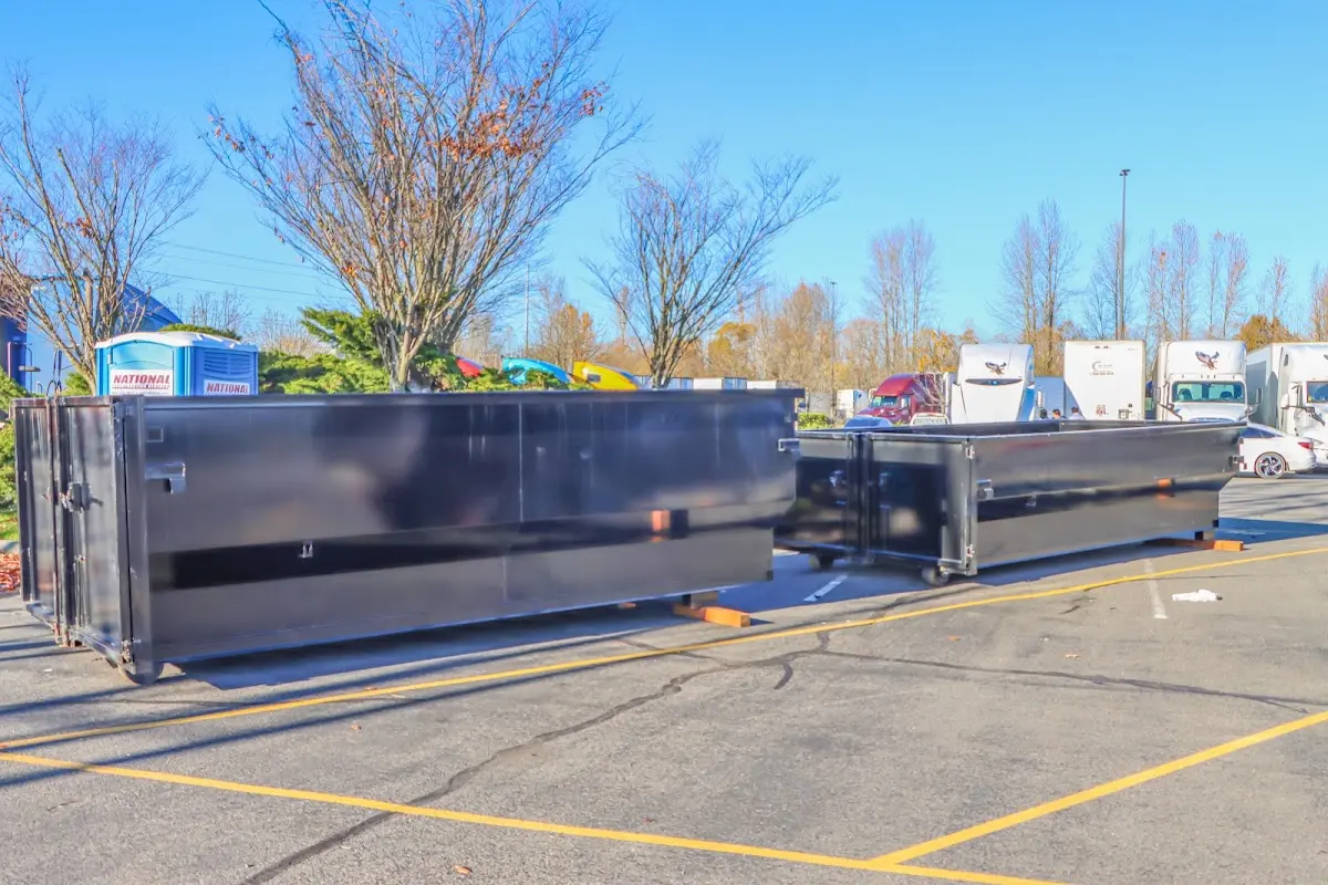 Professional dumpster rental service with roll-off container on residential driveway in Faribault